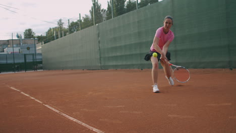 Junge-Kaukasische-Frau,-Die-Auf-Einem-Platz-Tennis-Spielt-Und-In-Zeitlupe-Einen-Ball-Zurückgibt